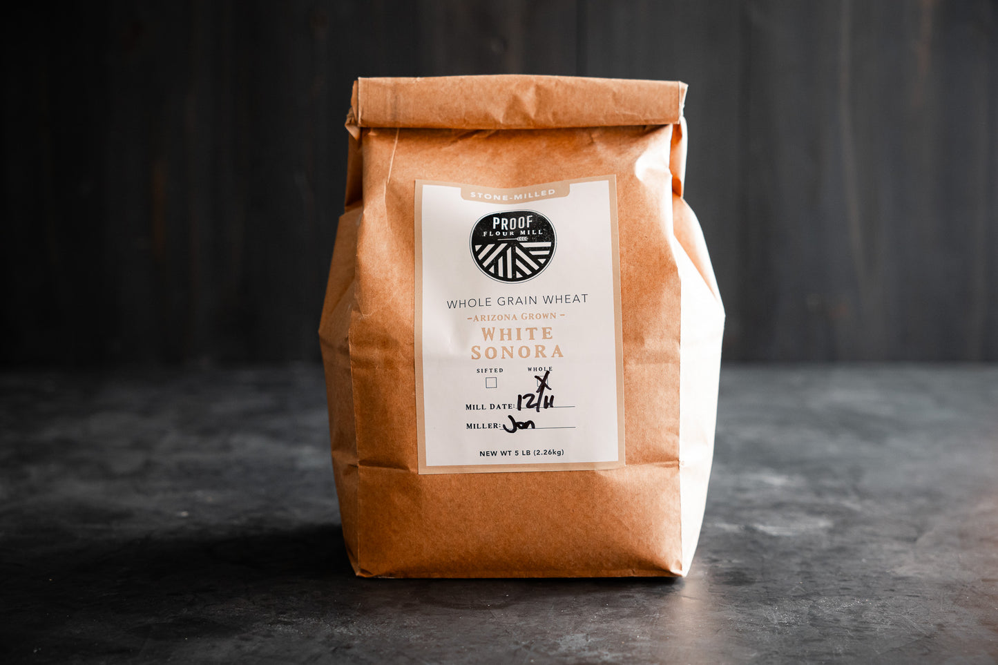 A bag of Arizona-grown White Sonora heritage wheat flour stone-milled by Proof Flour Mill.