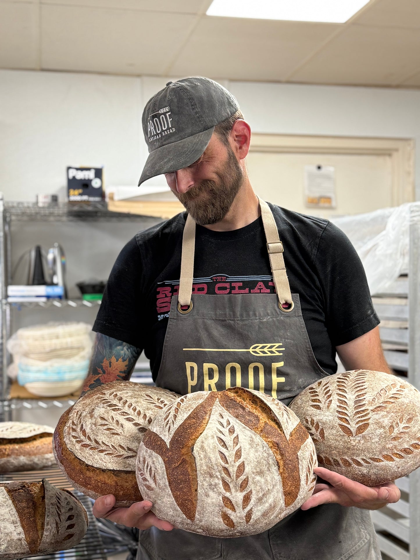 Our Shea location manager looking proud with his beautiful Proof Bread artisan sourdough miche creations.